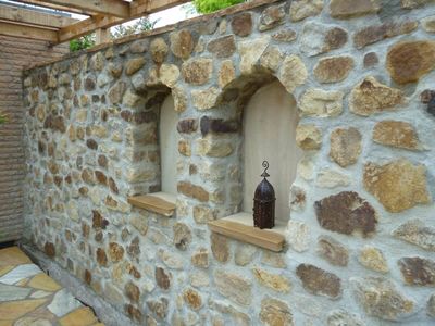 Referenzen aus 20 Jahren Gartenbau - Natursteinmauer mit Fenster